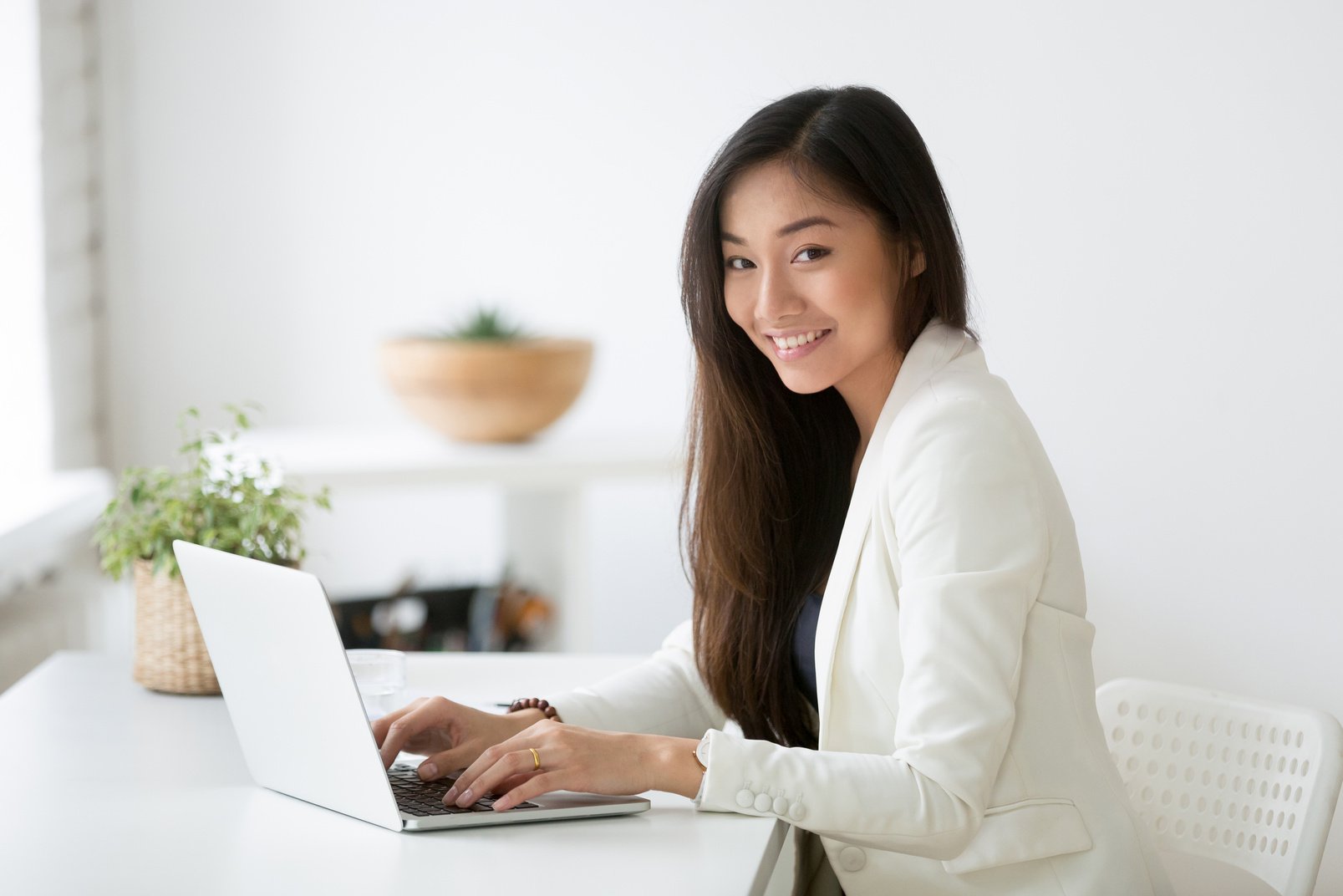 Portrait of female Asian professional posing smiling at camera